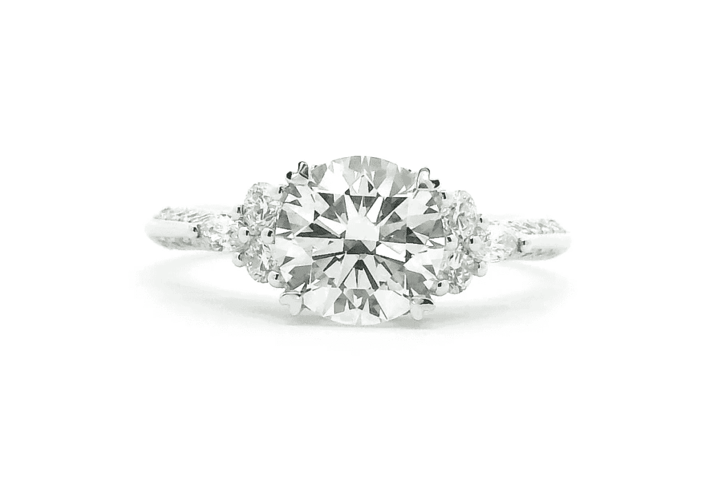 Engagement Rings 7 1.0ct diamond engagement ring with two round and two pear-shaped side stones in a bespoke trilogy design.